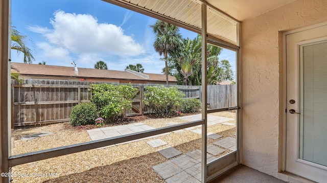 doorway to outside with a textured wall