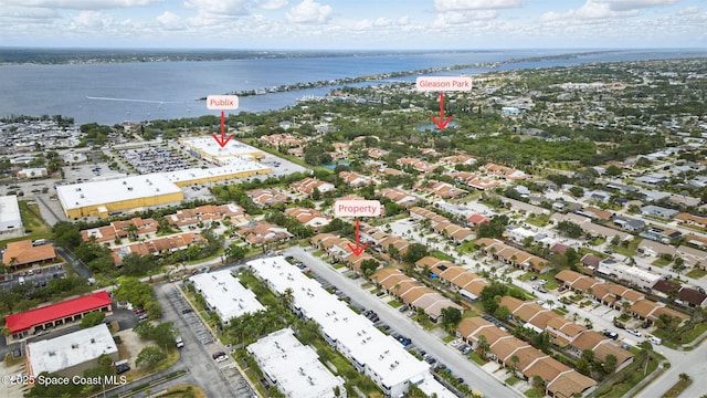 drone / aerial view with a residential view and a water view