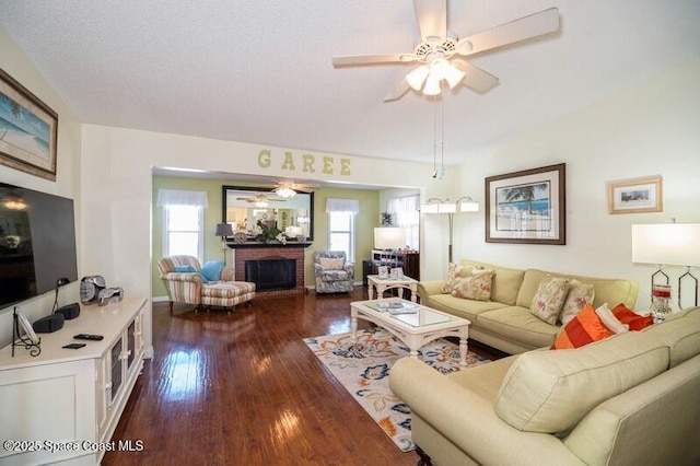 6190 Alderwood Ave, Cocoa, FL 32927 - living room featuring a brick fireplace, a ceiling fan, and dark wood-style floors