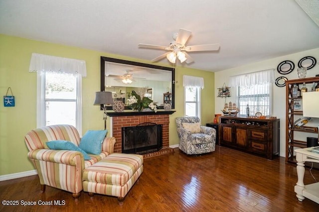 6190 Alderwood Ave, Cocoa, FL 32927 - living room with baseboards, ceiling fan, a brick fireplace, and wood finished floors