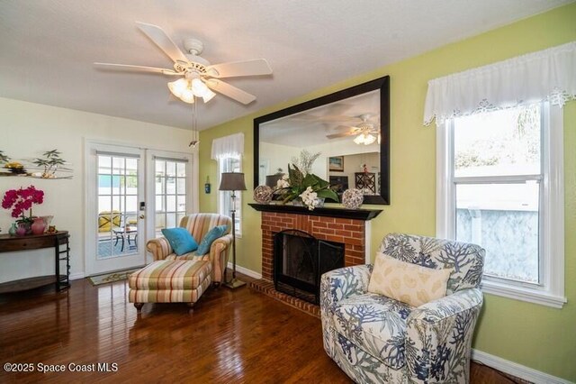 6190 Alderwood Ave, Cocoa, FL 32927 - living area featuring a ceiling fan, baseboards, wood finished floors, and a fireplace