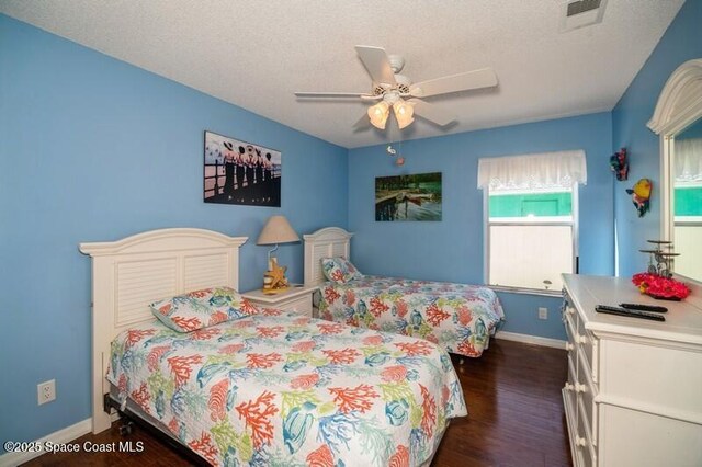 6190 Alderwood Ave, Cocoa, FL 32927 - bedroom featuring visible vents, baseboards, ceiling fan, a textured ceiling, and dark wood finished floors