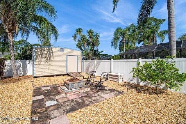 6190 Alderwood Ave, Cocoa, FL 32927 - view of patio / terrace with a fenced backyard, a storage unit, an outdoor structure, and an outdoor fire pit