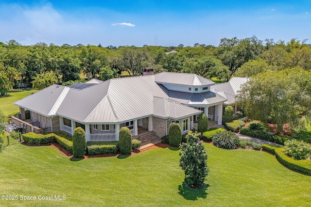 birds eye view of property with a view of trees