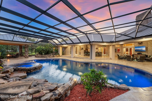 view of swimming pool featuring glass enclosure, a gazebo, a pool with connected hot tub, and a patio area