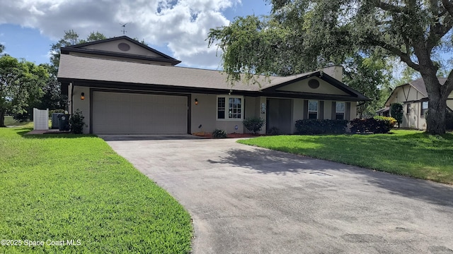view of front of home featuring an attached garage, driveway, a front lawn, and stucco siding