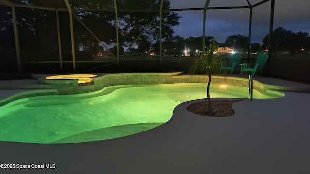 1428 Gleneagles Way, Rockledge, FL 32955 - pool at twilight featuring an in ground hot tub, a lanai, a patio, and an outdoor pool