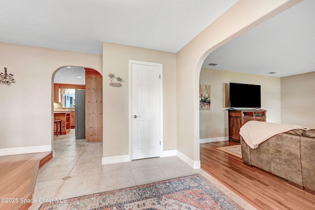 1428 Gleneagles Way, Rockledge, FL 32955 - interior space featuring visible vents, baseboards, light tile patterned flooring, and arched walkways