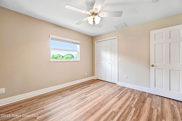 1428 Gleneagles Way, Rockledge, FL 32955 - unfurnished bedroom with a closet, visible vents, baseboards, ceiling fan, and light wood-style floors