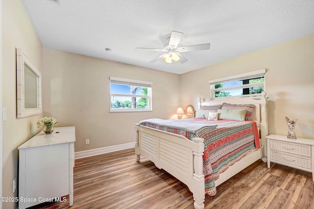 1428 Gleneagles Way, Rockledge, FL 32955 - bedroom with baseboards, light wood-style floors, ceiling fan, and a textured ceiling