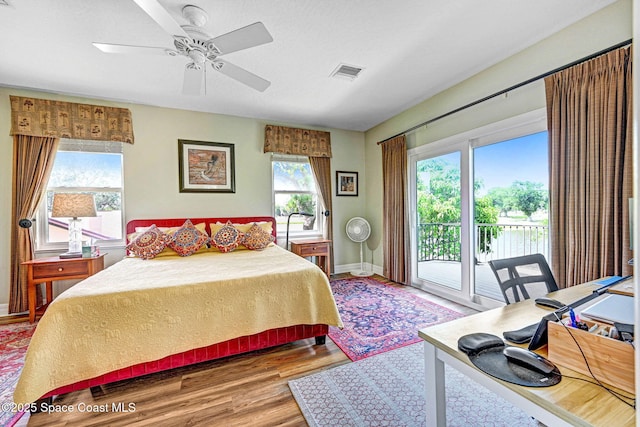 1428 Gleneagles Way, Rockledge, FL 32955 - bedroom featuring baseboards, ceiling fan, visible vents, access to outside, and wood finished floors