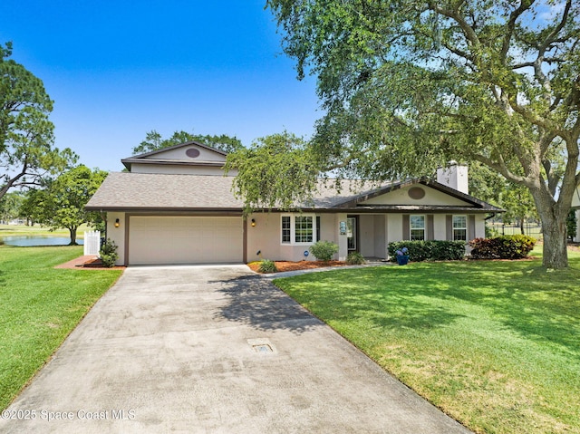 1428 Gleneagles Way, Rockledge, FL 32955 - view of front facade featuring driveway, stucco siding, a garage, and a front yard