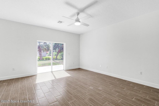 8050 96th Ave, Vero Beach, FL 32967 - empty room with wood finished floors, ceiling fan, baseboards, and a textured ceiling