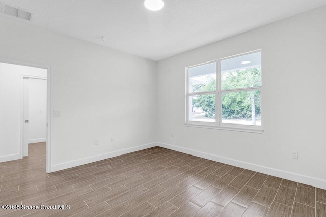 8050 96th Ave, Vero Beach, FL 32967 - empty room featuring baseboards and wood finish floors