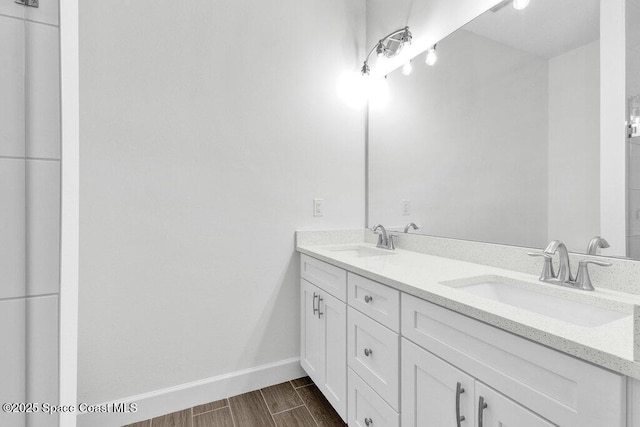 8050 96th Ave, Vero Beach, FL 32967 - bathroom featuring double vanity, baseboards, and wood finished floors