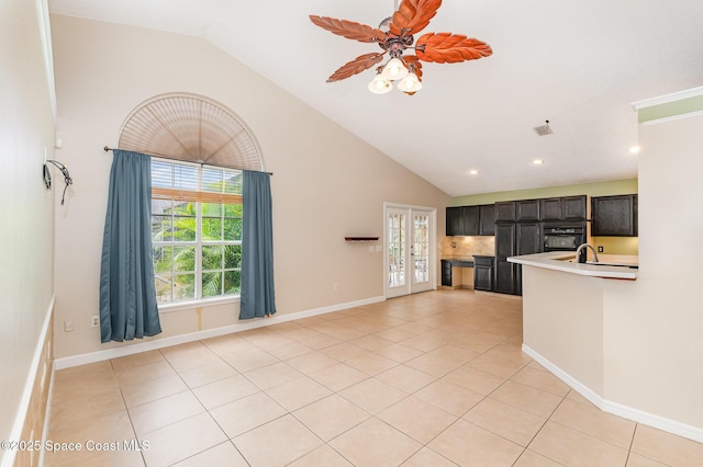 unfurnished living room with visible vents, baseboards, light tile patterned floors, and high vaulted ceiling