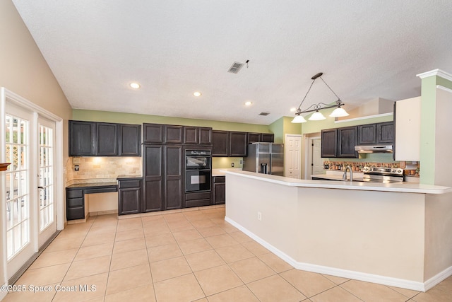 kitchen with backsplash, visible vents, lofted ceiling, under cabinet range hood, and stainless steel appliances