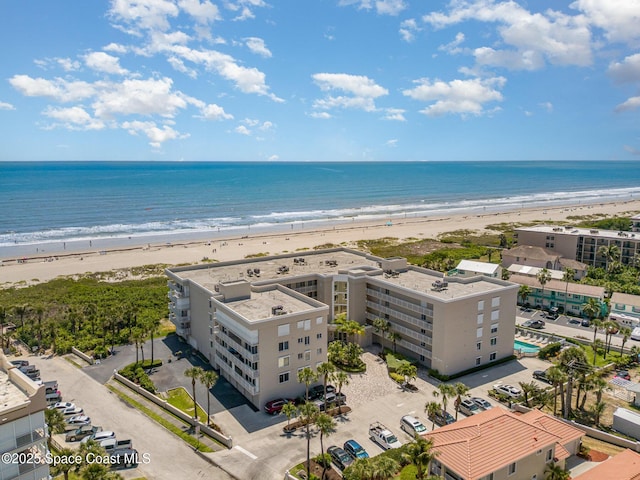 birds eye view of property featuring a view of the beach and a water view