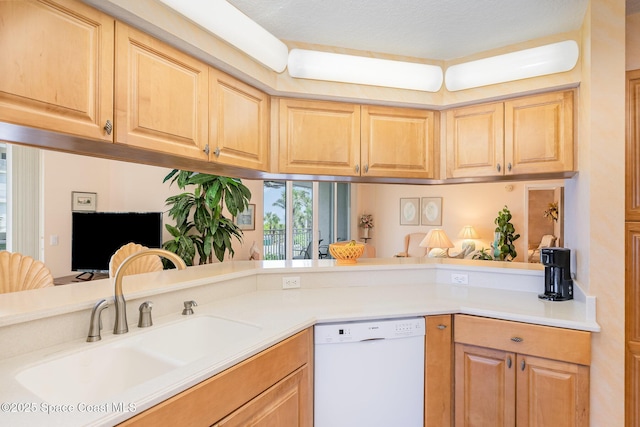 kitchen with a sink, light countertops, light brown cabinetry, and dishwasher