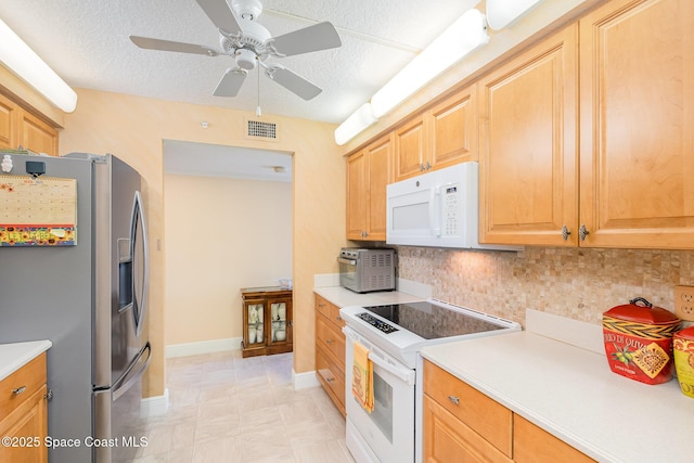 kitchen featuring visible vents, decorative backsplash, white appliances, and light countertops