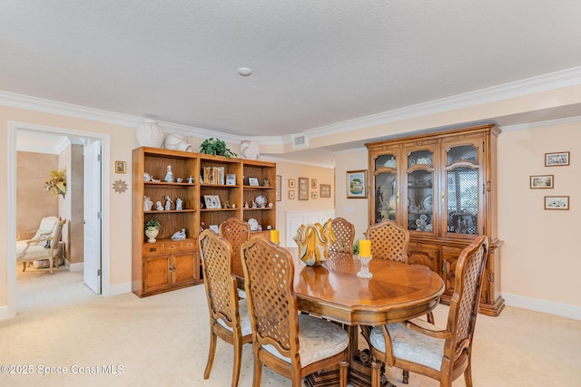dining area with crown molding, baseboards, visible vents, and light carpet