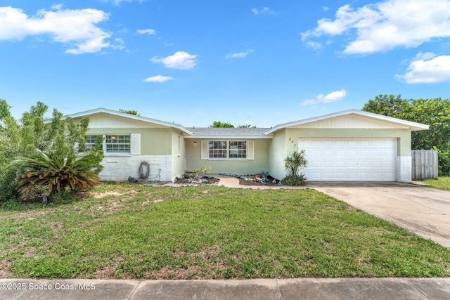 947 Bluewater Dr, Indian Harbour Beach, FL 32937 - ranch-style home featuring an attached garage, concrete driveway, a front lawn, and stucco siding