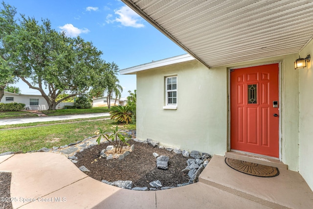 947 Bluewater Dr, Indian Harbour Beach, FL 32937 - doorway to property featuring stucco siding