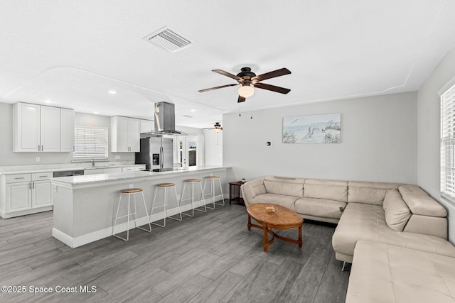947 Bluewater Dr, Indian Harbour Beach, FL 32937 - living room with light wood-style flooring, ceiling fan, and recessed lighting