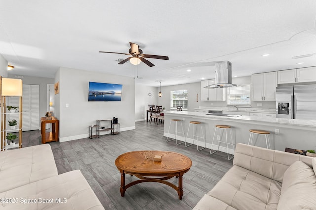947 Bluewater Dr, Indian Harbour Beach, FL 32937 - living area featuring wood finished floors, ceiling fan, and recessed lighting