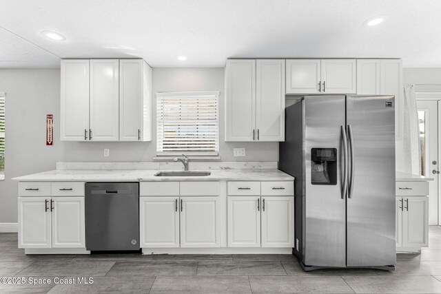 947 Bluewater Dr, Indian Harbour Beach, FL 32937 - kitchen featuring appliances with stainless steel finishes, white cabinetry, light stone counters, and recessed lighting
