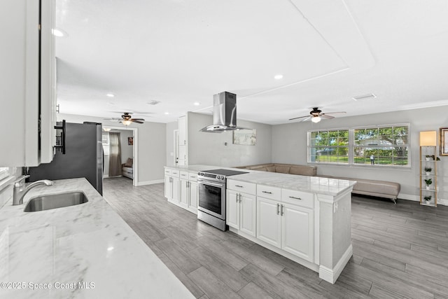 947 Bluewater Dr, Indian Harbour Beach, FL 32937 - kitchen featuring appliances with stainless steel finishes, exhaust hood, a ceiling fan, light wood-type flooring, and recessed lighting