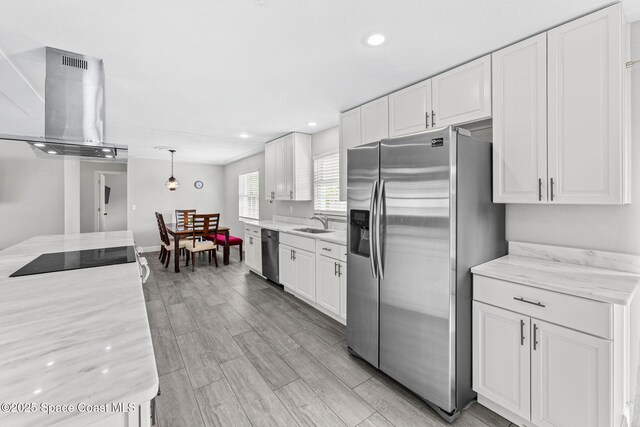947 Bluewater Dr, Indian Harbour Beach, FL 32937 - kitchen with stainless steel appliances, extractor fan, white cabinetry, recessed lighting, and light wood-style floors