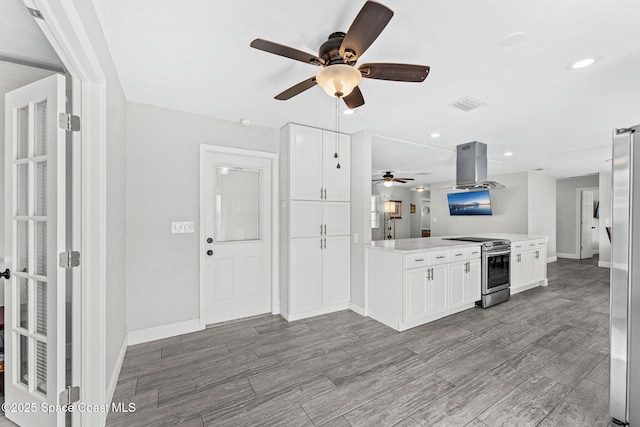 947 Bluewater Dr, Indian Harbour Beach, FL 32937 - kitchen featuring stainless steel appliances, a ceiling fan, white cabinetry, island range hood, and recessed lighting