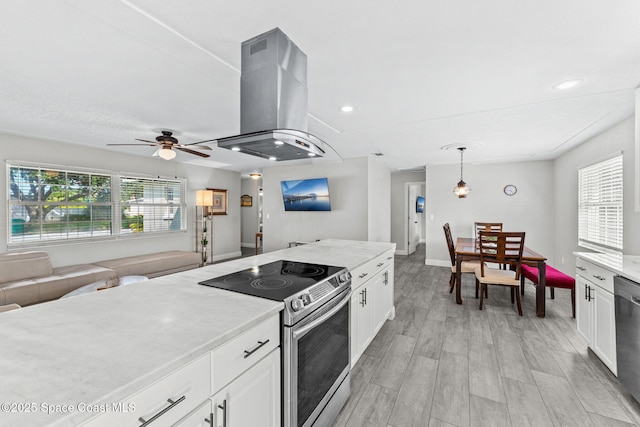 947 Bluewater Dr, Indian Harbour Beach, FL 32937 - kitchen with stainless steel appliances, island range hood, white cabinetry, and recessed lighting