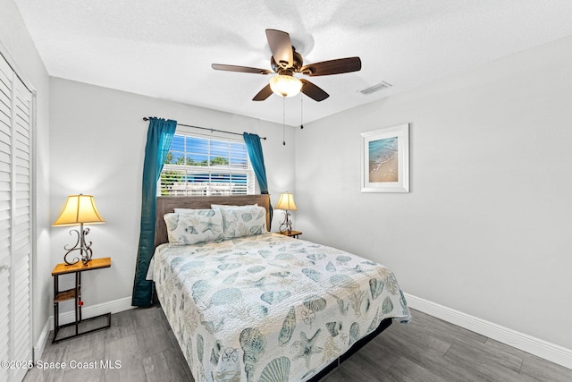947 Bluewater Dr, Indian Harbour Beach, FL 32937 - bedroom with wood finished floors, a ceiling fan, and a closet