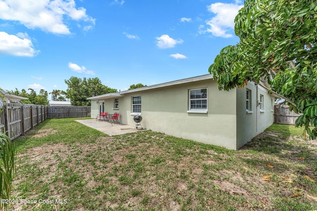 947 Bluewater Dr, Indian Harbour Beach, FL 32937 - rear view of property featuring a patio area, a fenced backyard, and stucco siding