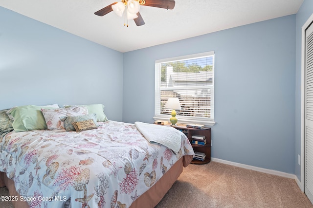 bedroom featuring carpet flooring, a ceiling fan, baseboards, and a closet