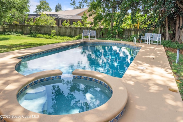 view of pool with a fenced backyard, a lawn, a pool with connected hot tub, and a patio area