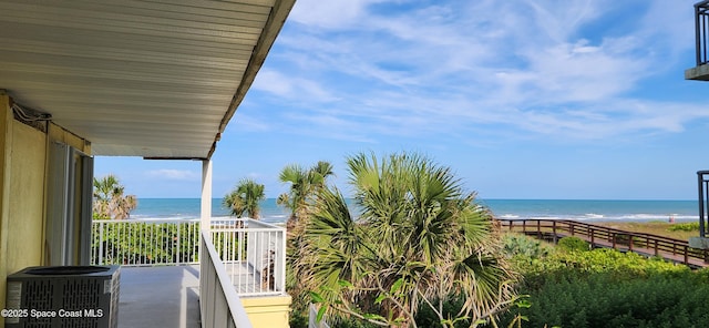 balcony featuring a water view, central AC, and a beach view