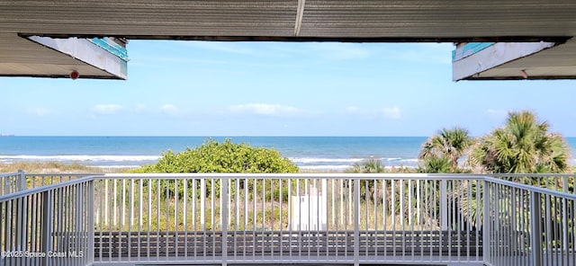exterior space featuring a water view and a beach view