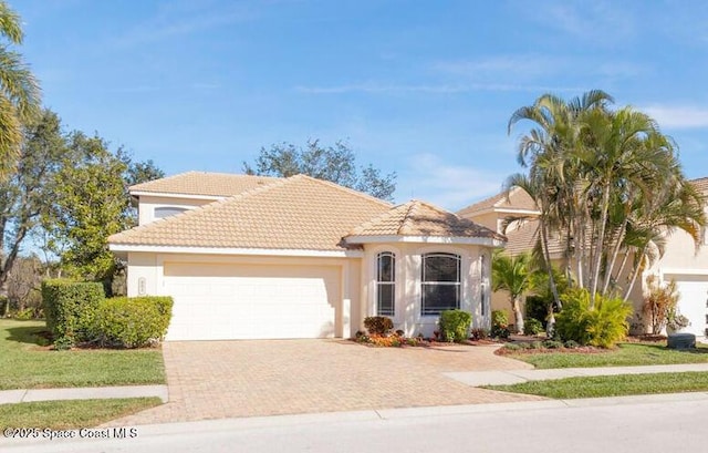 881 Glen Abbey Way, Melbourne, FL 32940 - view of front of home featuring an attached garage, decorative driveway, and stucco siding