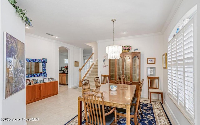 881 Glen Abbey Way, Melbourne, FL 32940 - dining space featuring stairway, arched walkways, an inviting chandelier, and a wealth of natural light