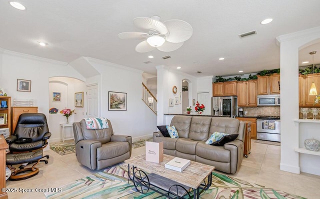 881 Glen Abbey Way, Melbourne, FL 32940 - living area with light tile patterned floors, arched walkways, ornamental molding, and visible vents