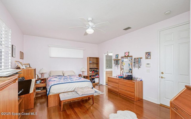 881 Glen Abbey Way, Melbourne, FL 32940 - bedroom featuring visible vents, connected bathroom, ceiling fan, and wood finished floors
