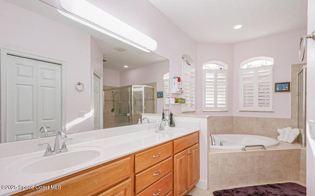 881 Glen Abbey Way, Melbourne, FL 32940 - bathroom featuring double vanity, a shower stall, a sink, and a garden tub