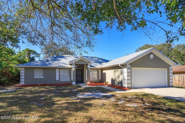 ranch-style house with a garage, driveway, a front yard, and stucco siding