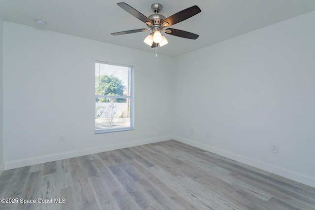 unfurnished room with baseboards, ceiling fan, and light wood-type flooring