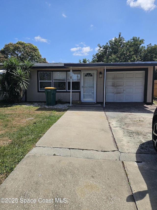 single story home with an attached garage, driveway, and a front yard