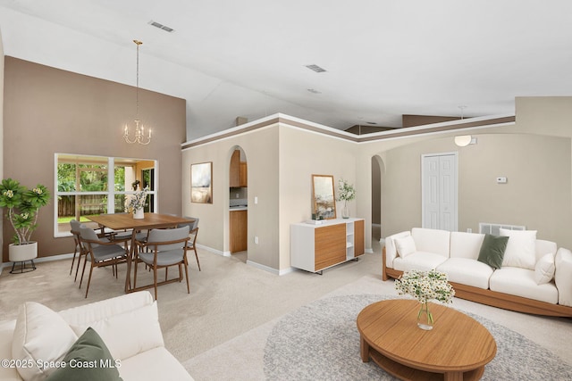 7416 Camio Ave, Cocoa, FL 32927 - living room with arched walkways, light colored carpet, a chandelier, lofted ceiling, and baseboards
