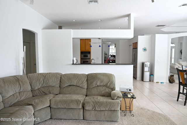 321 Brightwater Dr SE, Palm Bay, FL 32909 - living room with arched walkways and light tile patterned floors